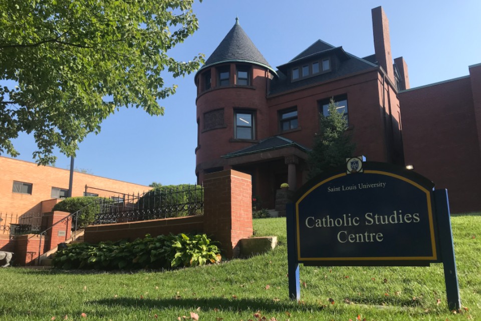 Exterior of the 3-story brick building with a sign that reads Catholic Studies Center