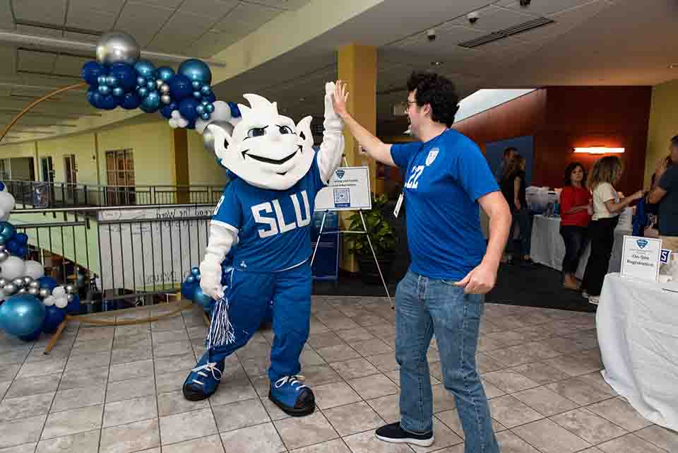 The Billiken shares a high five during a Homecoming and Family Weekend event at the Busch Student Center. Photo by Luke Yamnitz.