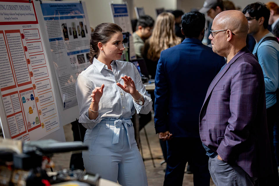 Victoria Ervin explains her poster “The Captivating Curiosity Initiative” during the Senior Legacy Symposium on May 2, 2023. Photo by Sarah Conroy. 