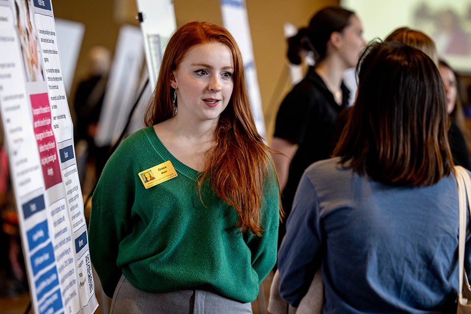 Grace Mohr explains her poster “Adaptive Dance for Youth with Disabilities”  during the Senior Legacy Symposium on May 2, 2023. Photo by Sarah Conroy. 