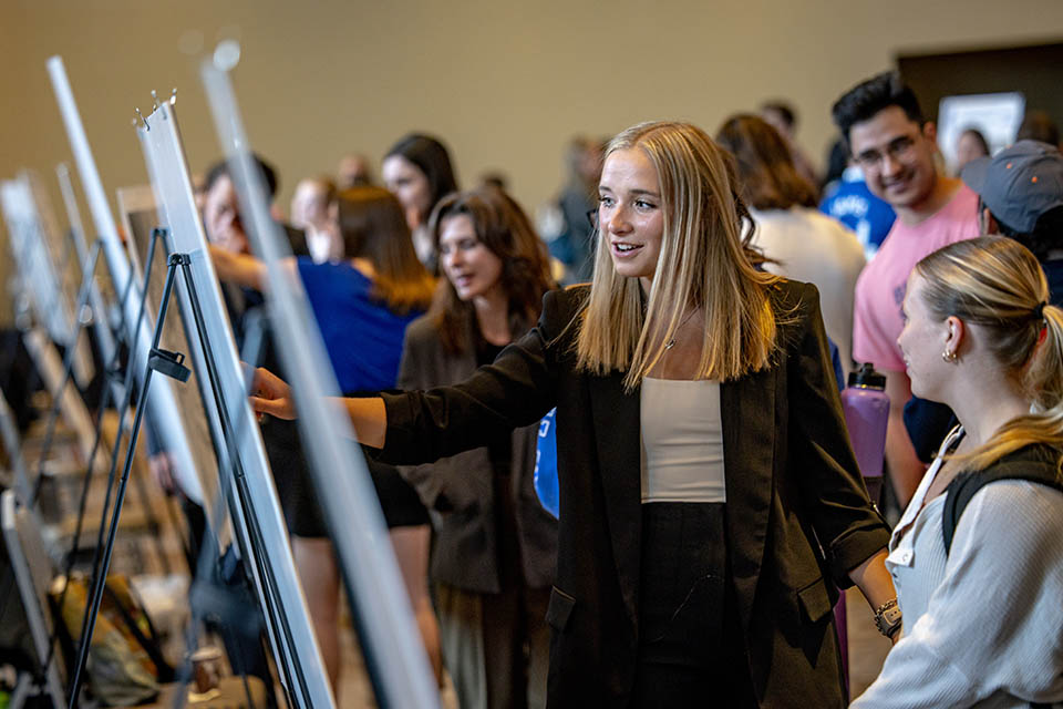 Seniors exhibit posters of their research projects during the Senior Legacy Symposium on May 2, 2023. Photo by Sarah Conroy. 