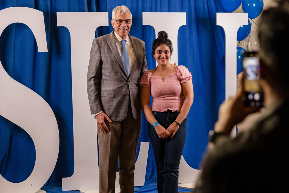 President Fred P. Pestello, Ph.D., takes photos with students during the International Services President’s Reception on Monday, Sept. 18. Photo by Sarah Conroy. 