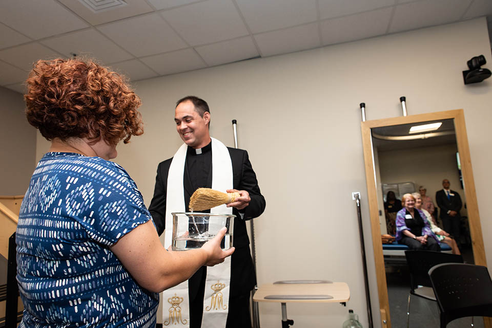 The Carolyn Gioia Learning Lab is blessed during a celebration of SLU's physical therapy program's 90th anniversary. Photo by Luke Yamnitz.