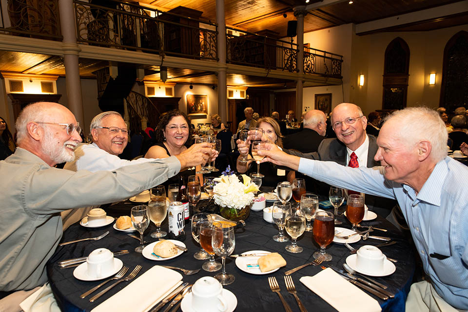 SLU's newest Golden Billikens toast at a dinner held for graduates from the classes of 1972 and 1973. Photo by Luke Yamnitz.