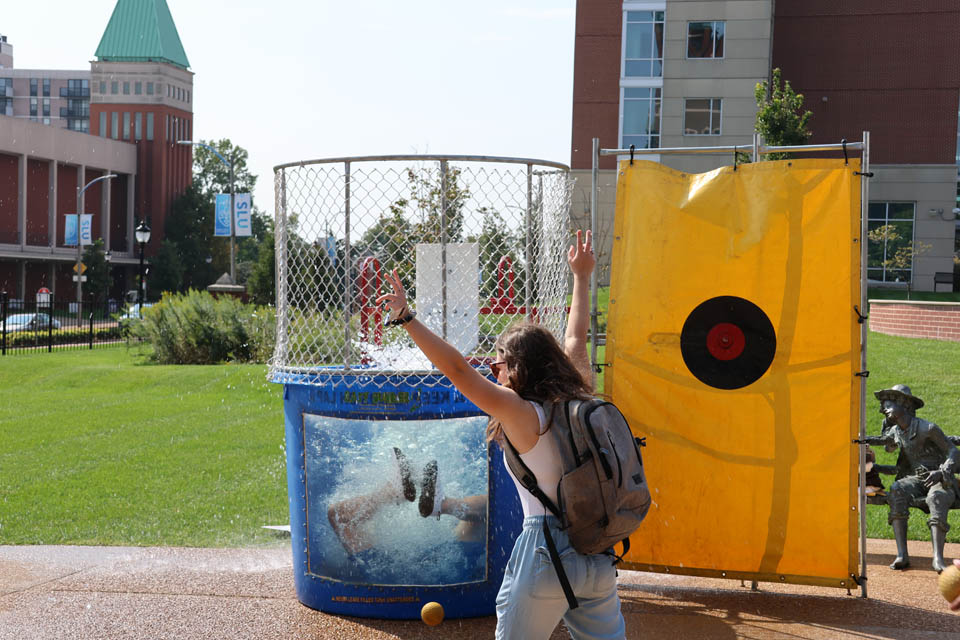 A SLU student celebrates dunking SLU men's basketball coach Travis Ford on Friday, Sept. 22. The dunk tank was an event organized by the Department of Athletics and the Student Homecoming Committee. Photo by Joe Barker. 