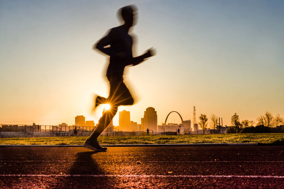 A runner gets a head start on the day by running around the medical center track on April 21, 2023. Photo by Sarah Conroy.