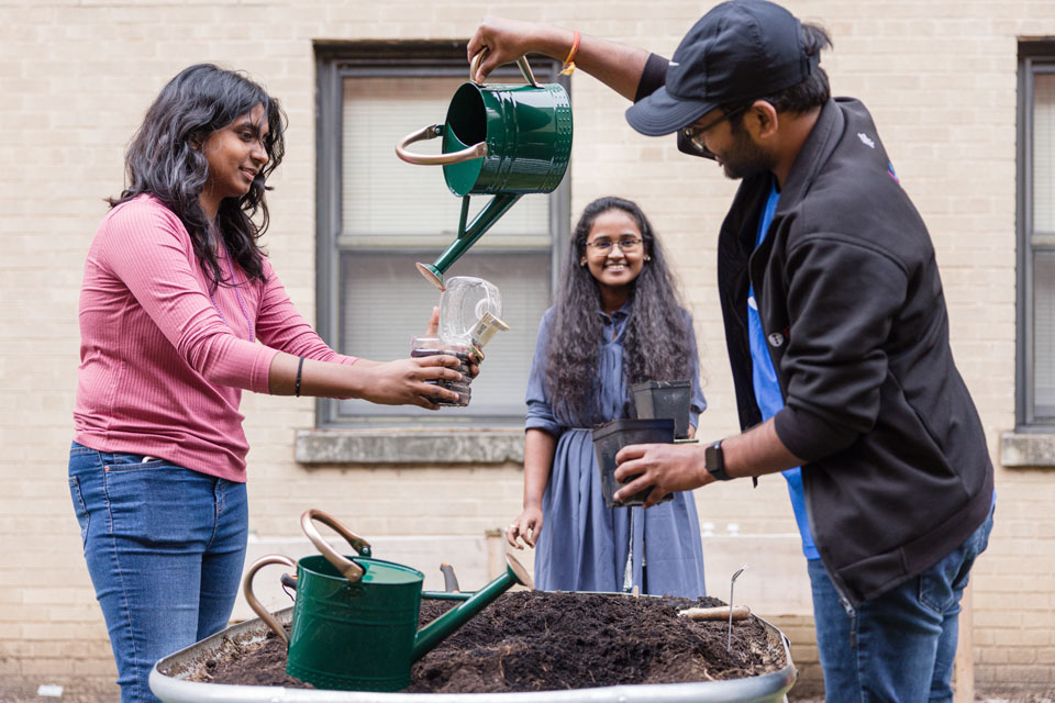 Students plant in the Wellness Garden as part of Seed SLU during wellness day on Friday, Feb. 9. Photo by Sarah Conroy.