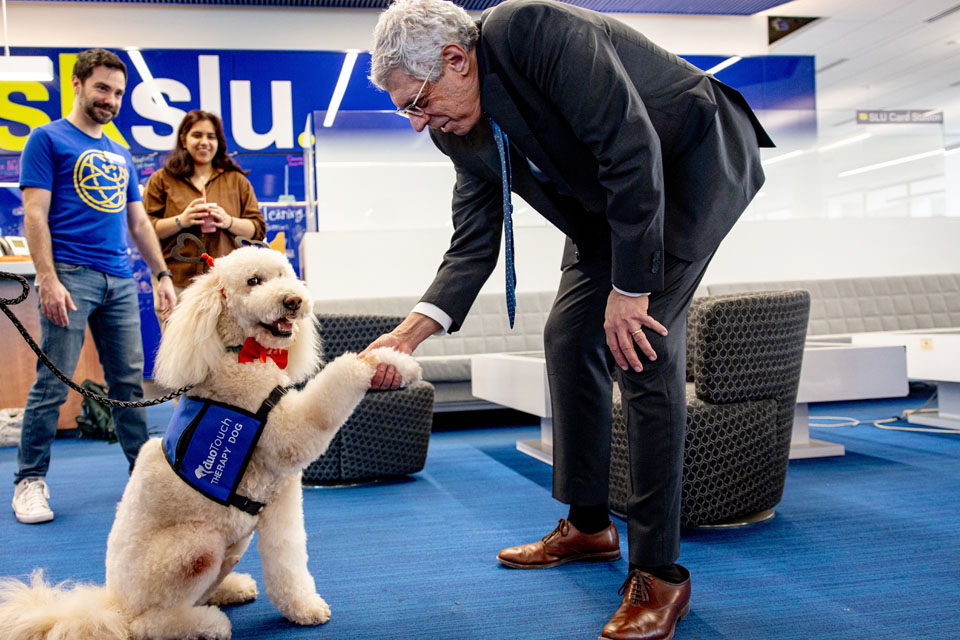 President Fred P. Pestello, Ph.D., meets Doug, a DuoTouch Therapy Dog, during wellness day on Friday. Feb. 9. Photo by Sarah Conroy.

