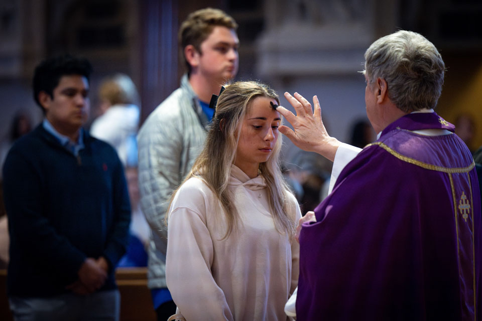 Members of the SLU community receive ashes during Ash Wednesday Mass at St. Francis Xavier College Church on  Wednesday, Feb. 14. Photo by Sarah Conroy.