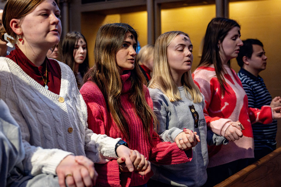 Members of the SLU community pray together during Ash Wednesday Mass at St. Francis Xavier College Church on Wednesday, Feb. 14. Photo by Sarah Conroy.