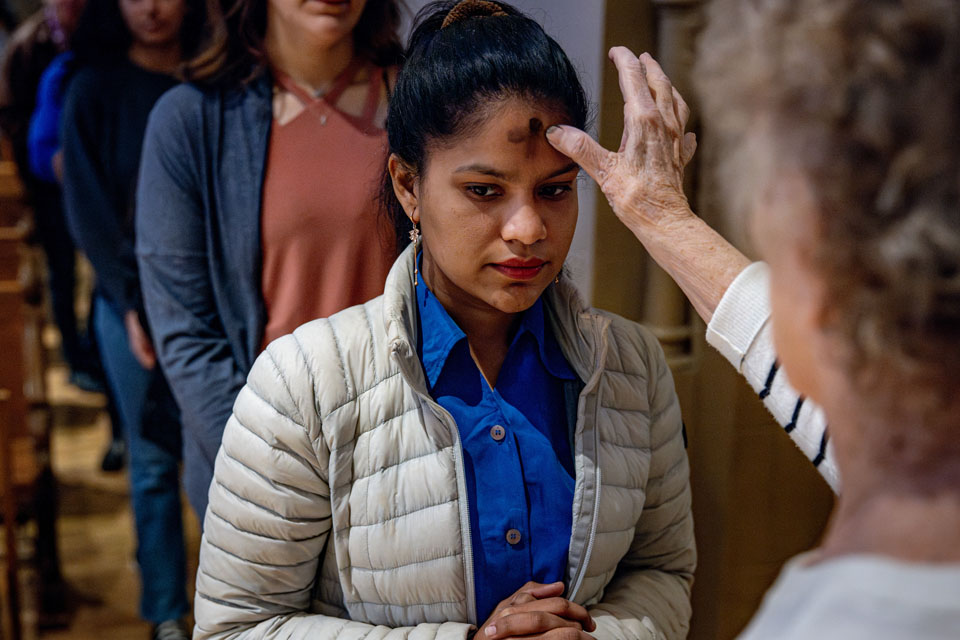 Members of the SLU community receive ashes during Ash Wednesday Mass at St. Francis Xavier College Church on  Wednesday, Feb. 14. Photo by Sarah Conroy.