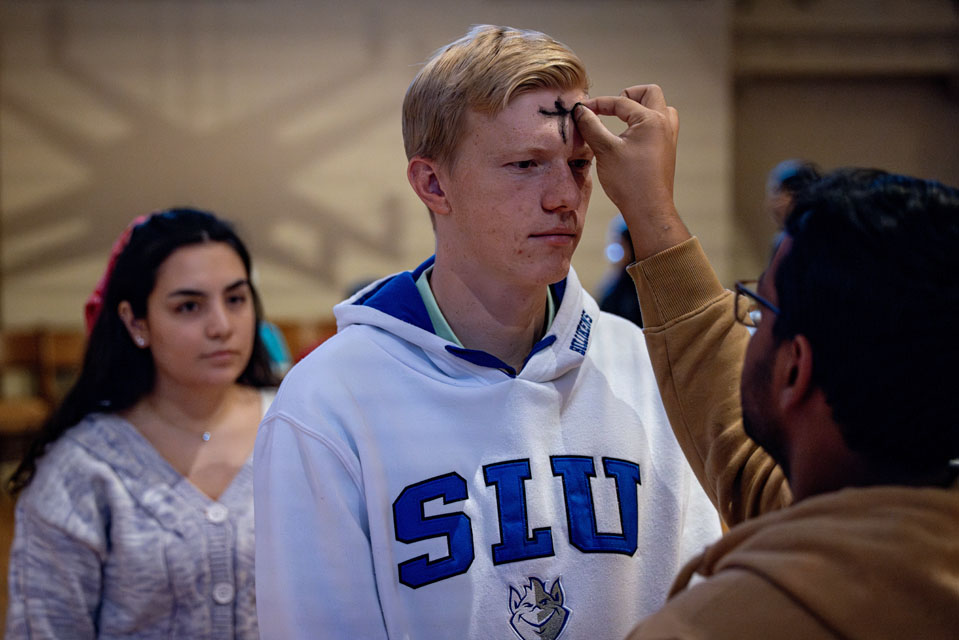 Members of the SLU community receive ashes during Ash Wednesday Mass at St. Francis Xavier College Church on  Wednesday, Feb. 14. Photo by Sarah Conroy.