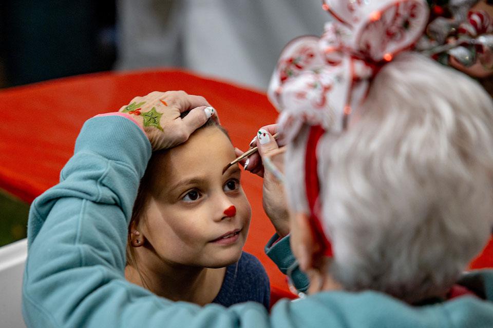 A child gets her face painted at Christmas on the Quad. Photo by Sarah Conroy.