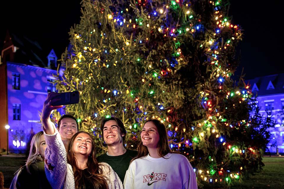 A group of attendees pose for a selfie at Christmas on the Quad. Photo by Sarah Conroy.