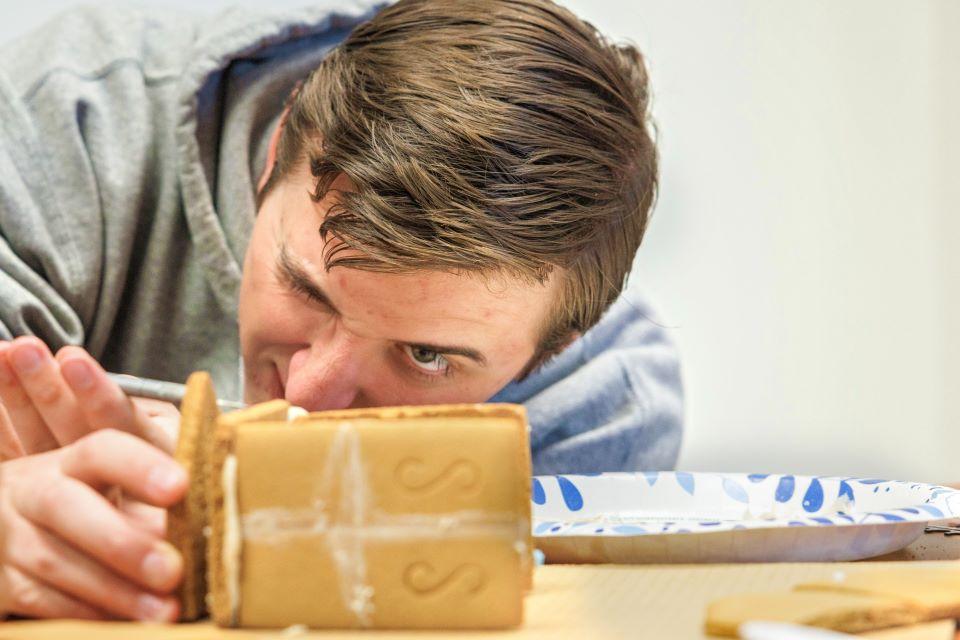 Clayton Stout checks to make sure that the pieces of the gingerbread house are level for the SSE Innovation Challenge on December 2, 2024. Photo by Sarah Conroy.