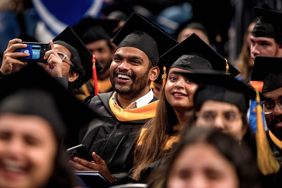 Graduates laugh during the Midyear Commencement on De. 14, 2024. Photo by Sarah Conroy. 