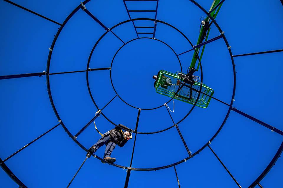 Members of facility services disassemble the 38-foot Christmas tree on the corner of Grand and Lindell Blvds.on January 10, 2024. This photo took second place in the University Photographers Association monthly photo contest. Photo by Sarah Conroy. 