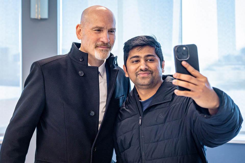 President-elect Edward Feser, Ph.D., takes a selfie with a student during a reception at the Allied Health Building on January 13, 2025. Photo by Sarah Conroy. 