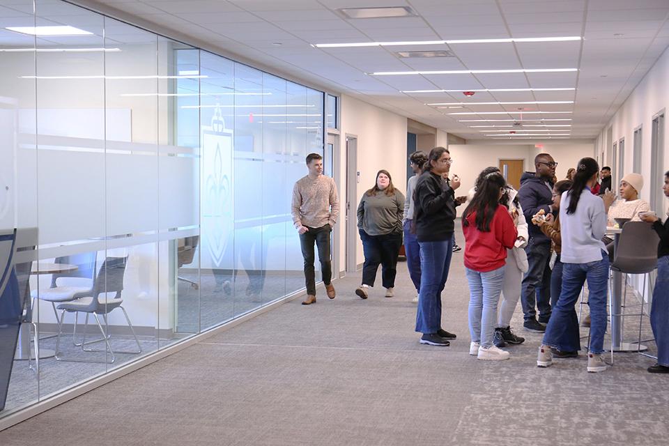 A hallway equipped with floor-to-ceiling glass runs the distance of the second floor and provides a wide walking space with natural lighting for students. 