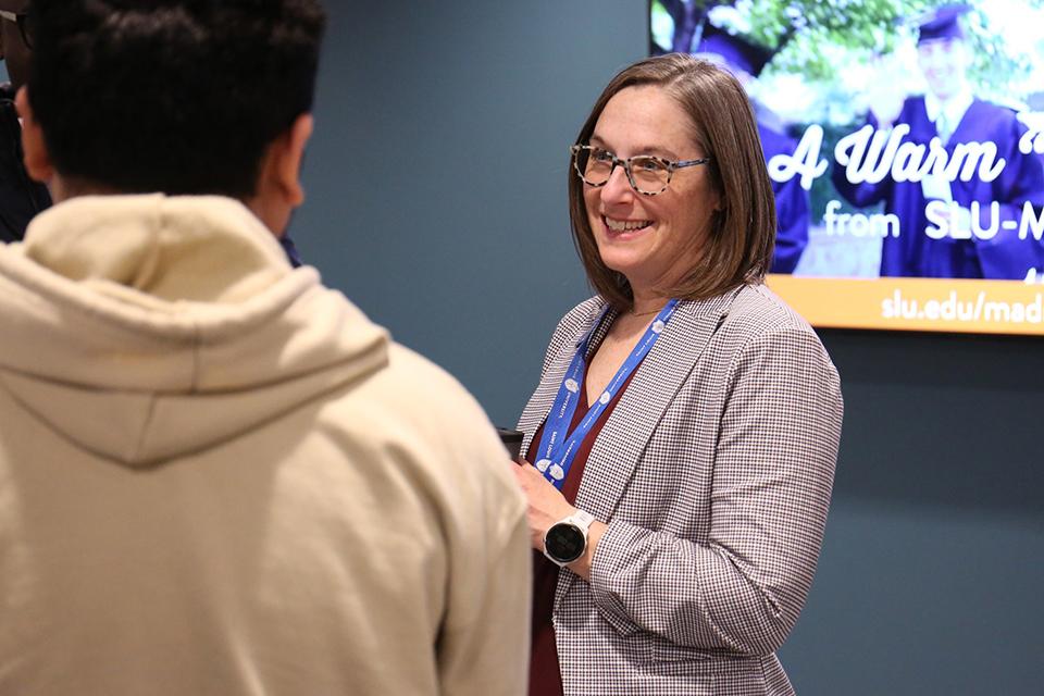 Dean Leslie McClure, Ph.D. talks with students during an event on the first day of classes in the second floor of the Wool Center.