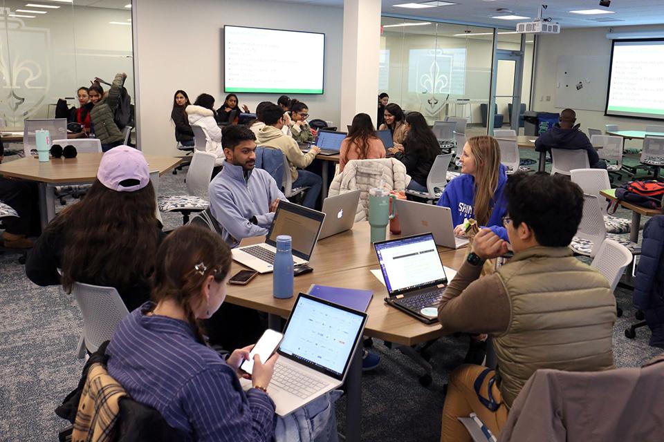 The first class of the semester for students takes place in a classroom in the second floor of the Wool Center.