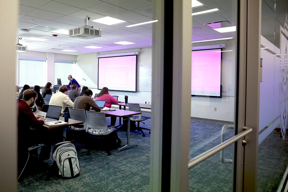 The Wool Center's second floor has many classrooms with large glass walls. 