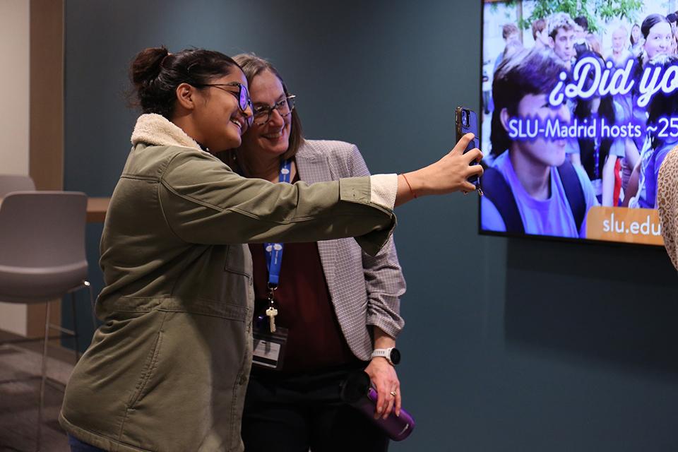 Dean Leslie McClure, Ph.D. takes a selfie with a student on the first day of class during the 'Donuts with the Dean' event in the Wool Center.