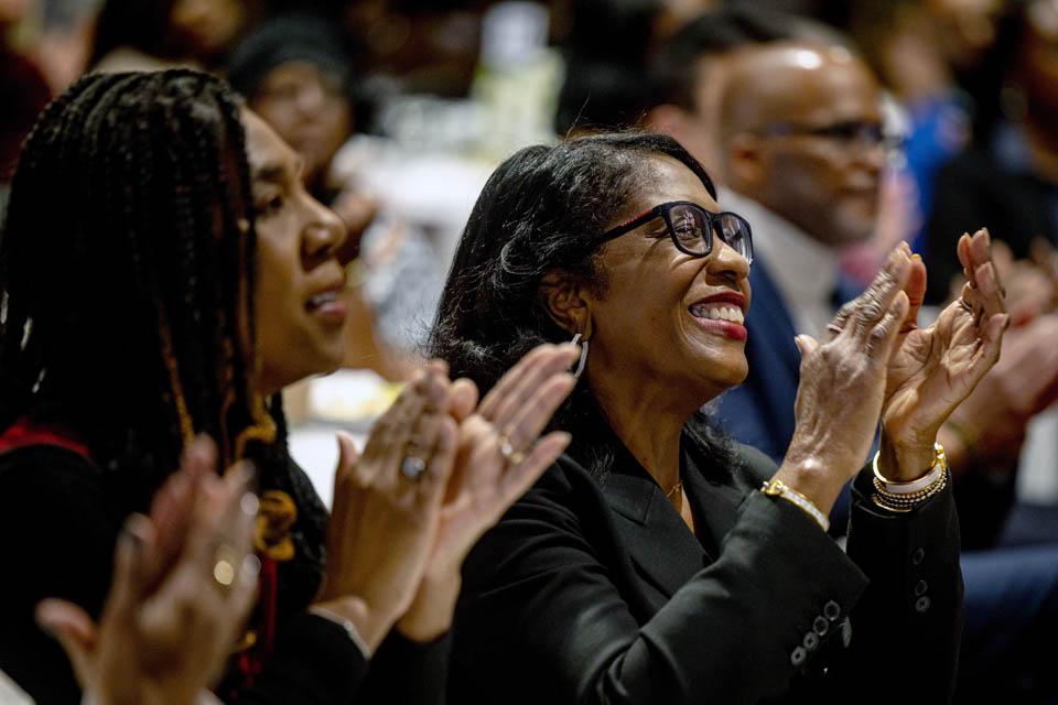 Rochelle D. Smith, vice president of the Division of Diversity and Innovative Community Engagement, right, applauds during the Martin Luther King Jr. Memorial Tribute on Jan. 23, 2025. Photo by Sarah Conroy. 