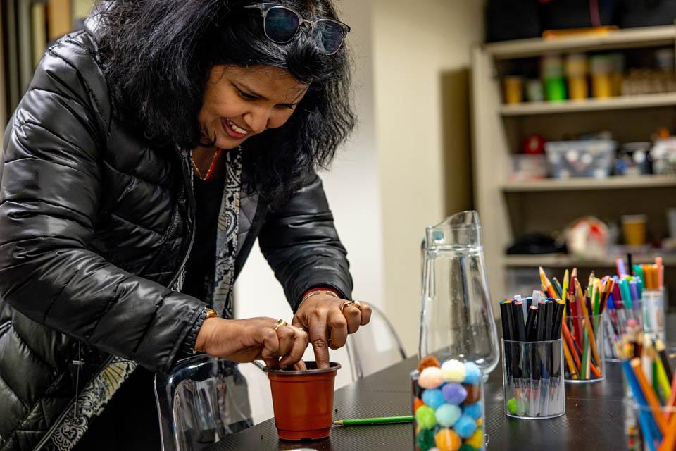 A student plants seeds during the Garden Wellness Series event for Wellness Day on Feb. 5, 2025. Photo by Sarah Conroy. 