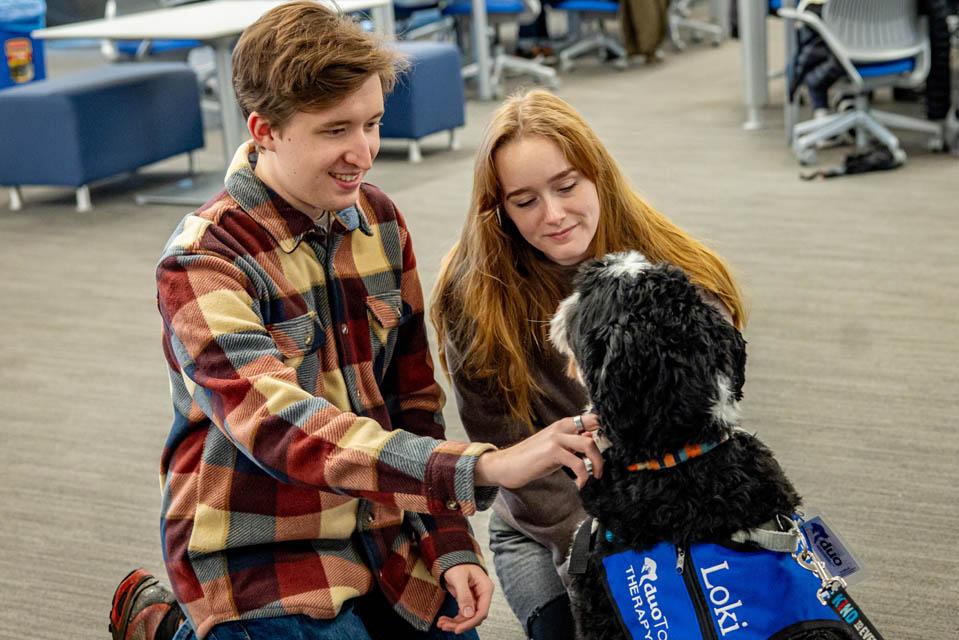 Students pet Duo Dog Loki during Wellness Day on Feb. 5, 2025. Photo by Sarah Conroy. 