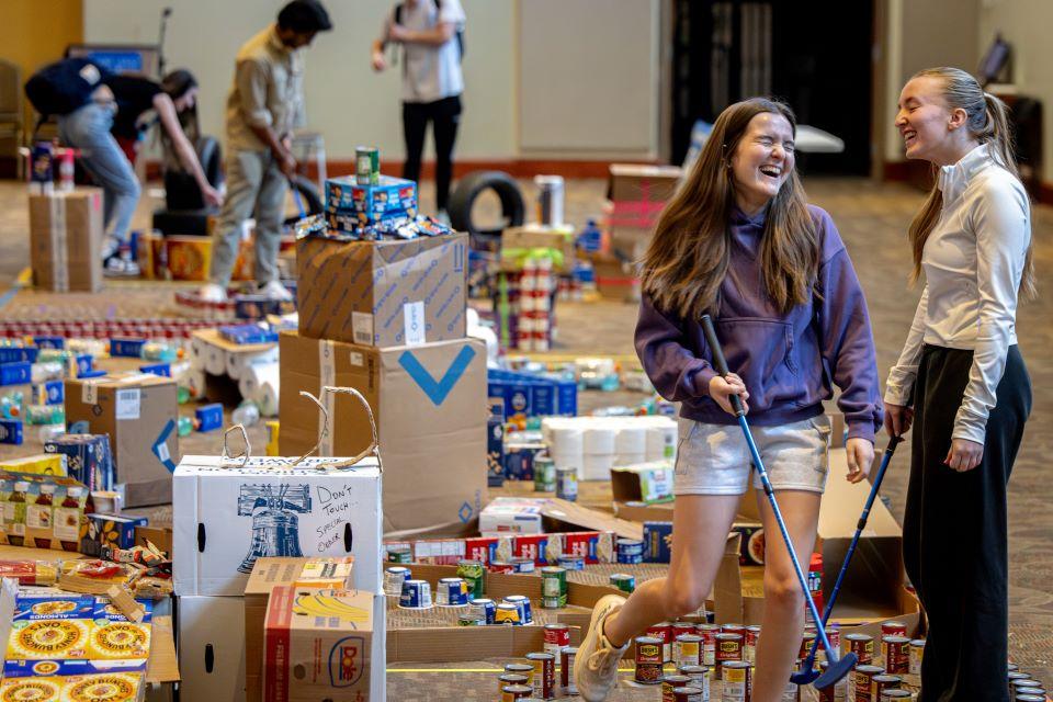 Members of the SLU community play miniature golf on a course constructed from shelf-stable grocery items at Golf and Give, an SSE Innovation Challenge to benefit Billiken Bounty on February 25, 2025. Photo by Sarah Conroy.