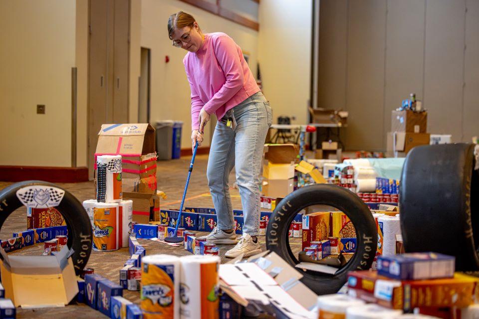 Members of the SLU community play miniature golf on a course constructed from shelf-stable grocery items at Golf and Give, an SSE Innovation Challenge to benefit Billiken Bounty on February 25, 2025. Photo by Sarah Conroy.