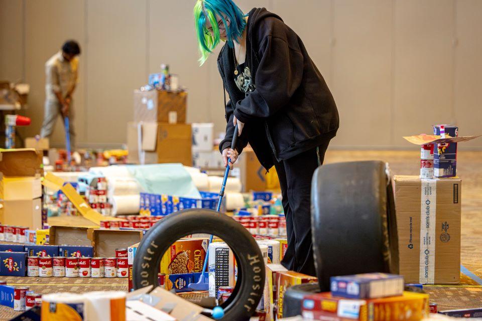 Members of the SLU community play miniature golf on a course constructed from shelf-stable grocery items at Golf and Give, an SSE Innovation Challenge to benefit Billiken Bounty on February 25, 2025. Photo by Sarah Conroy.