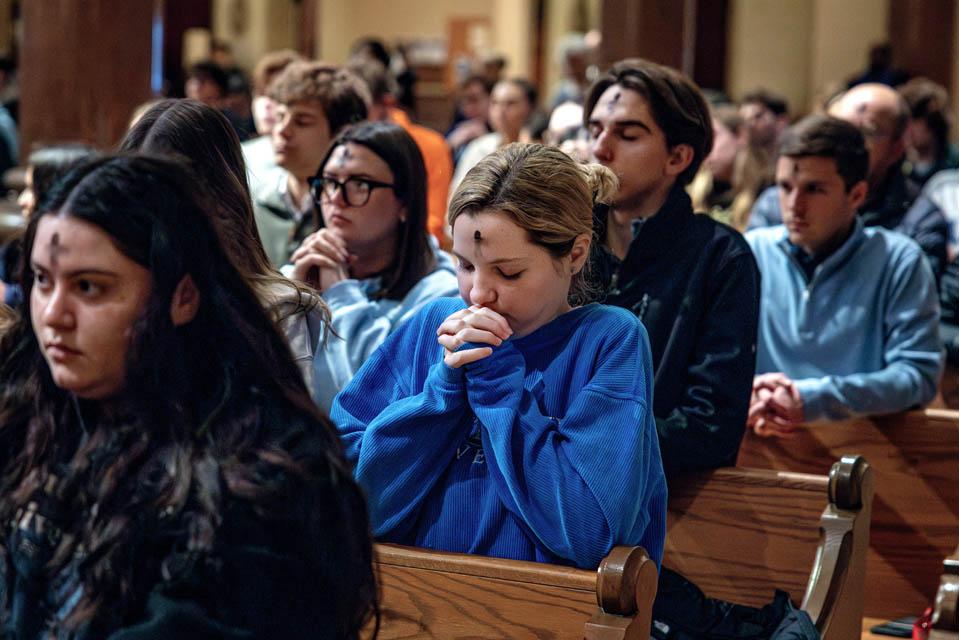 Students pray during Ash Wednesday Mass at St. Francis Xavier College Church on March 5, 2025. Photo by Sarah Conroy. 

