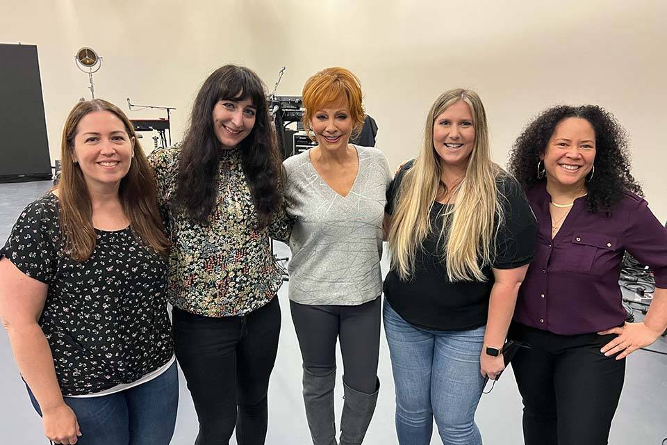 Leah and Reba Leah (Ducey) Dougherty poses for a photo with Reba McEntire and three others.
