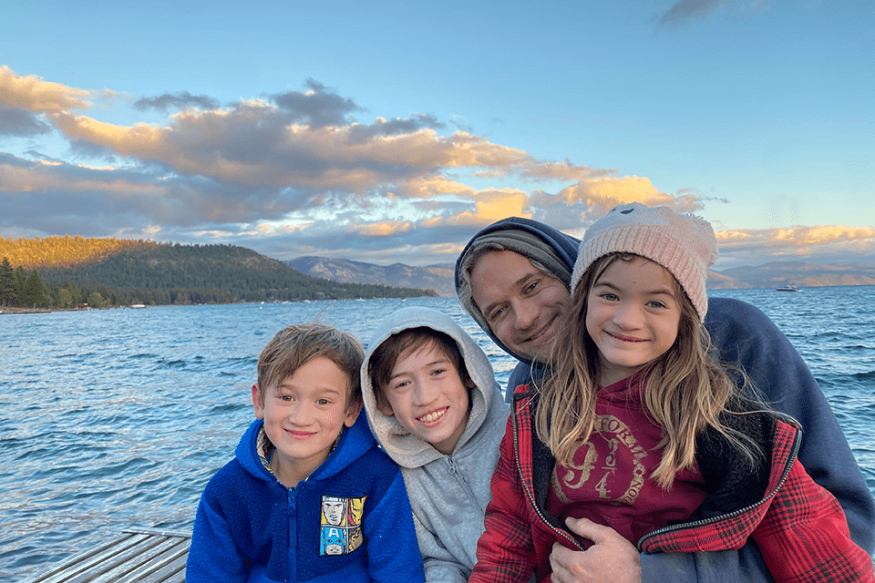 Travis Hoffstetter (A&S ‘05), poses for a photo with his three children.