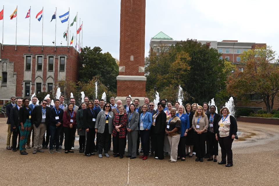 ajcu deans conference attendees pose in front of clock tower at SLU