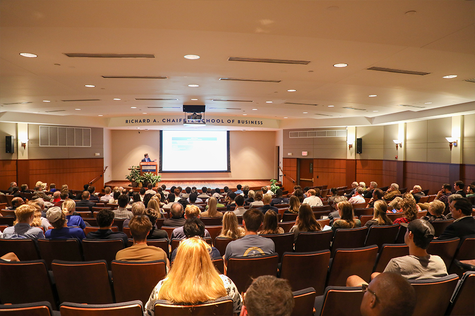 Ron Kruszewksi speaks to an auditorium of nearly 200 people. 