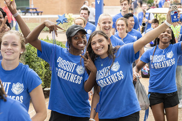 Students on campus wearing SLU gear, headed to an event 