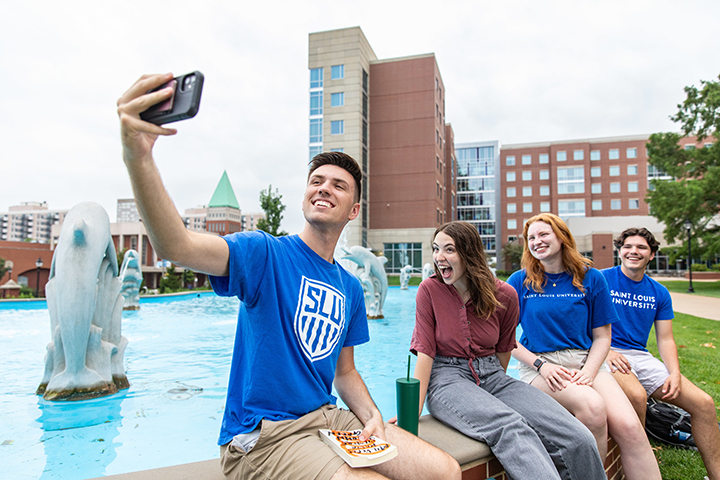 Students take a selfie at SLU's dolphin pond