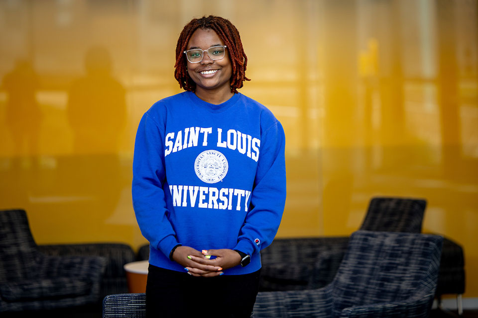 Malaisyah Vann poses for a photo wearing a blue Saint Louis University sweatshirt.