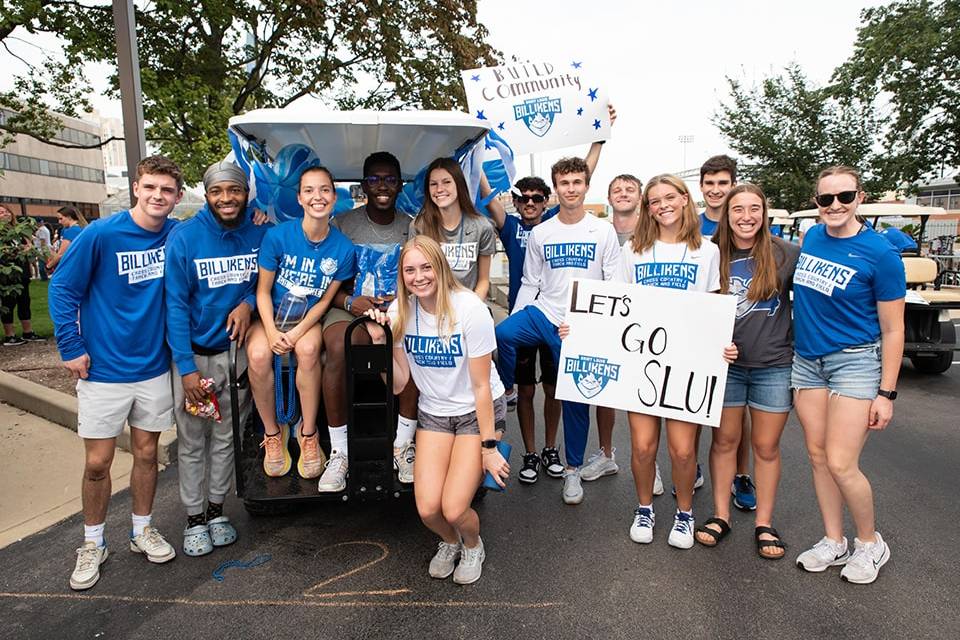 Two images placed side by side. Each one contains a photo of a student sitting in front of a chess board. They both wear t-shirts that read "Saint Louis University Chess Team"