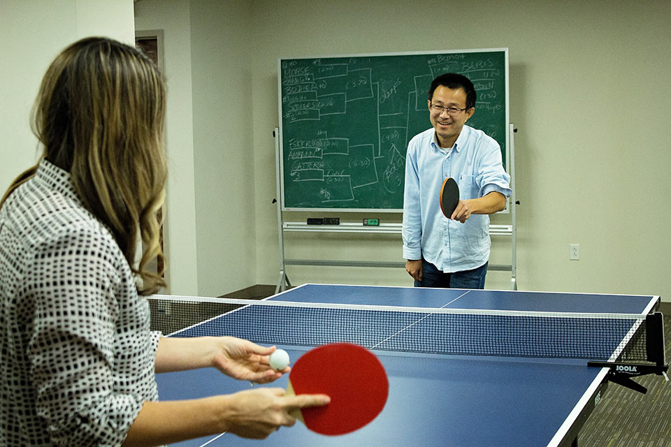 Miao Zhang plays ping-pong with SLU LAW faculty and students during the 2017 Ping Pong Tournament.