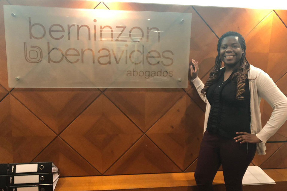 Codi Cox poses in front of the Berninzon & Benavides Abogados sign.