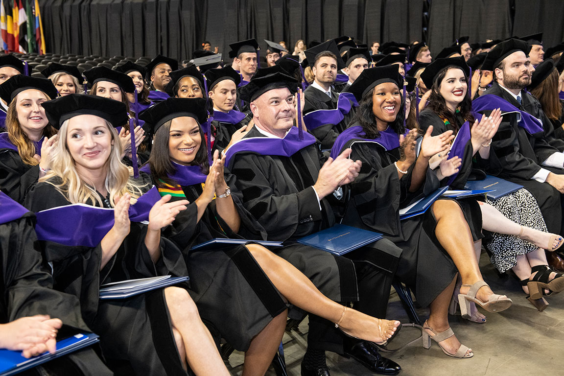 Graduates applaud following the keynote address of the ceremony.