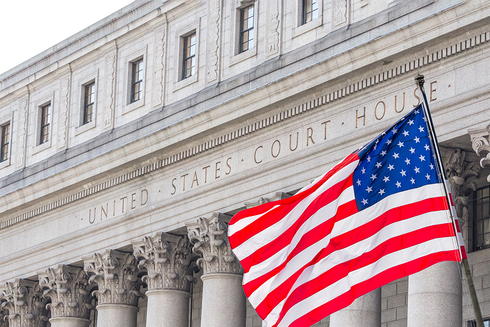 picture of the United States Supreme Court building with a flag 