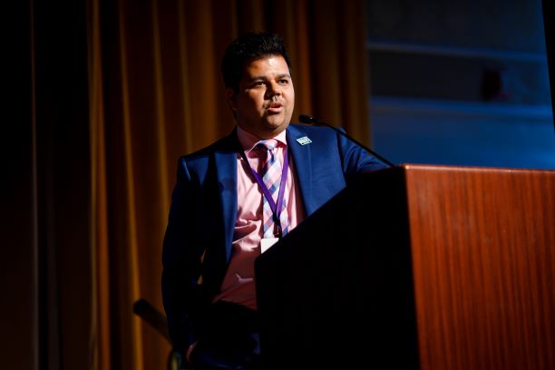 Professor Michael Sinha Speaks at the Podium