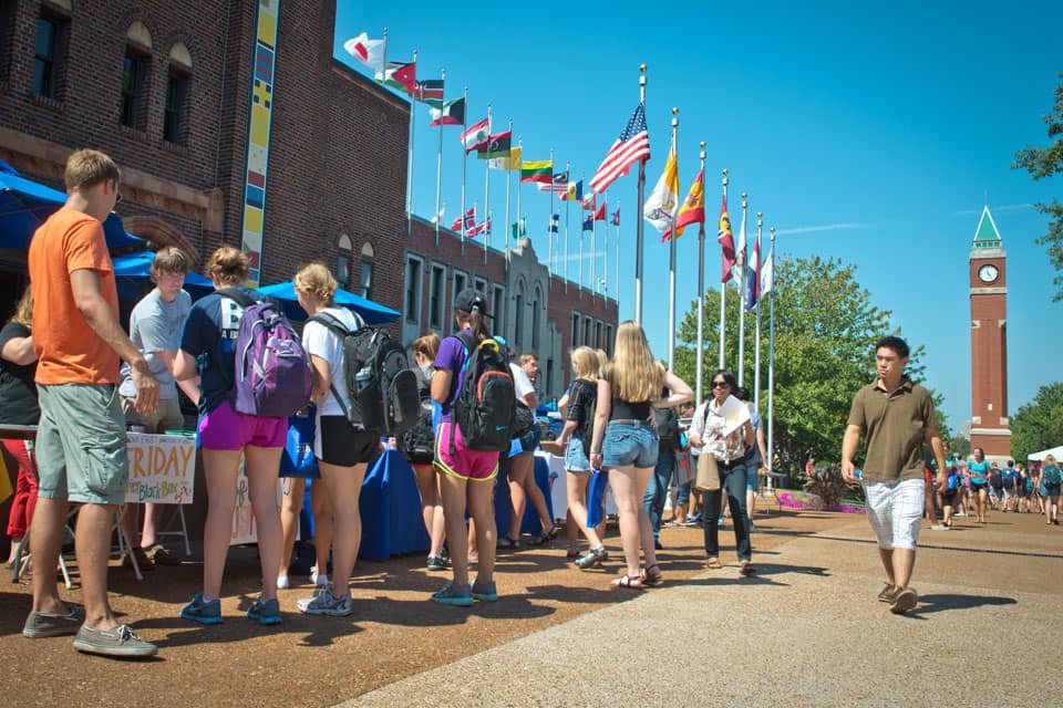 Students stand around informational tables on West Pine Mall.