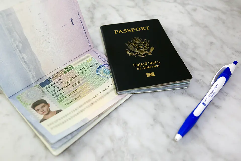 A passport, a visa and a blue pen.
