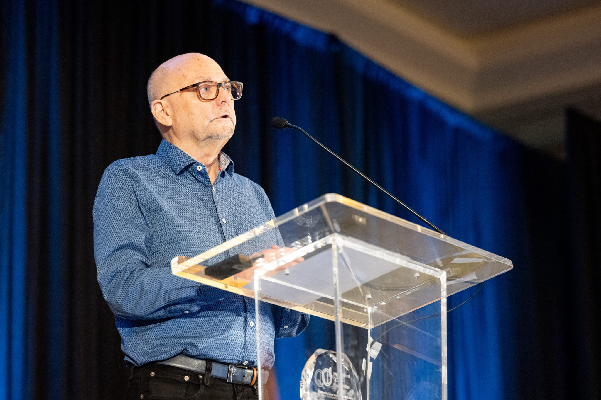 Alec Pollard, Ph.D., addresses an audience after receiving the International OCD Foundation’s 2024 Outstanding Career Achievement Award.